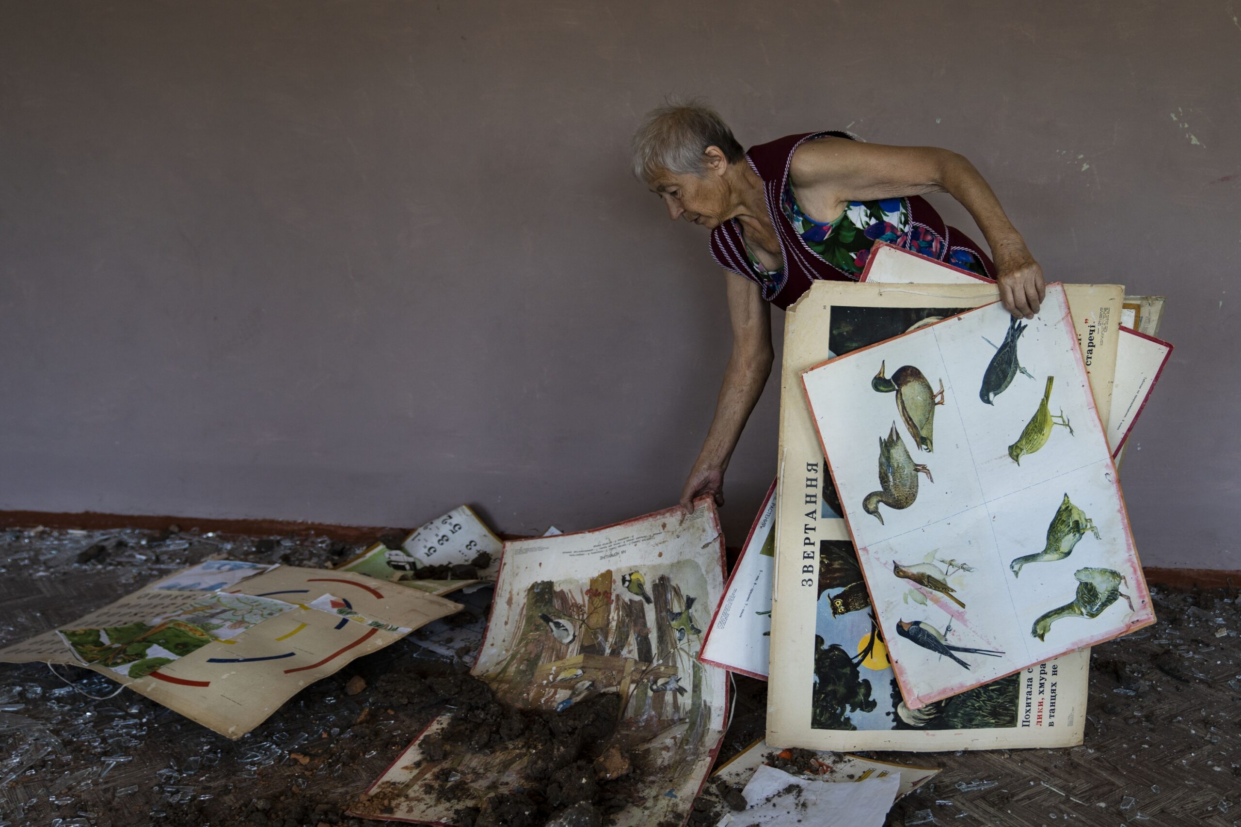 Ekaterina Bogdanova cleans a school in Kharkiv following a Russian missile strike